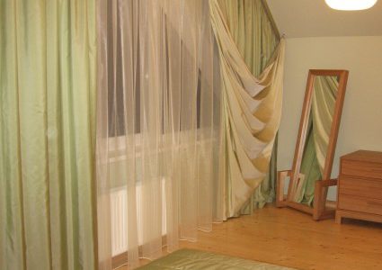 green non standard window curtains in bedroom